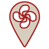 Icône de géolocalisation rouge et beige avec une croix basque au centre, symbole de l'ancrage territorial du Bakery Bliss Café